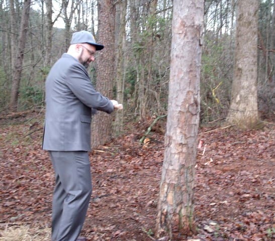 TMC President Emir Caner swings an ax at a tree as part of  ceremony 