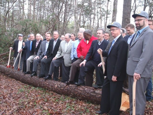 TMC President Emir Caner and Board of Trustee stand at a symbolic downed tree 