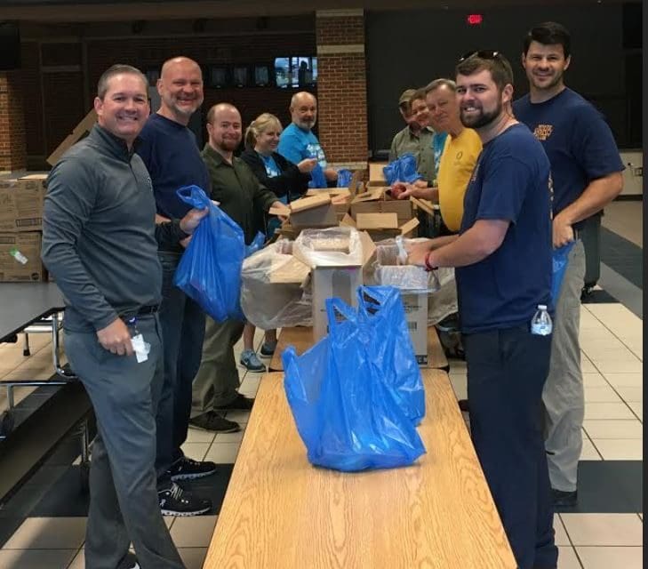 Rotarian’s Assist With Summer Meal Packaging